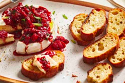 Brie and topped with warm cherry chutney, served with toasted bread.