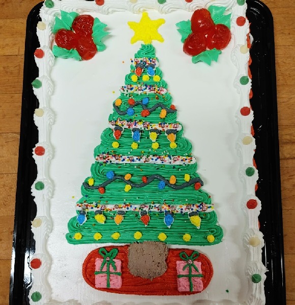 A sheet cake with an image of a decorated Christmas with presents underneath.